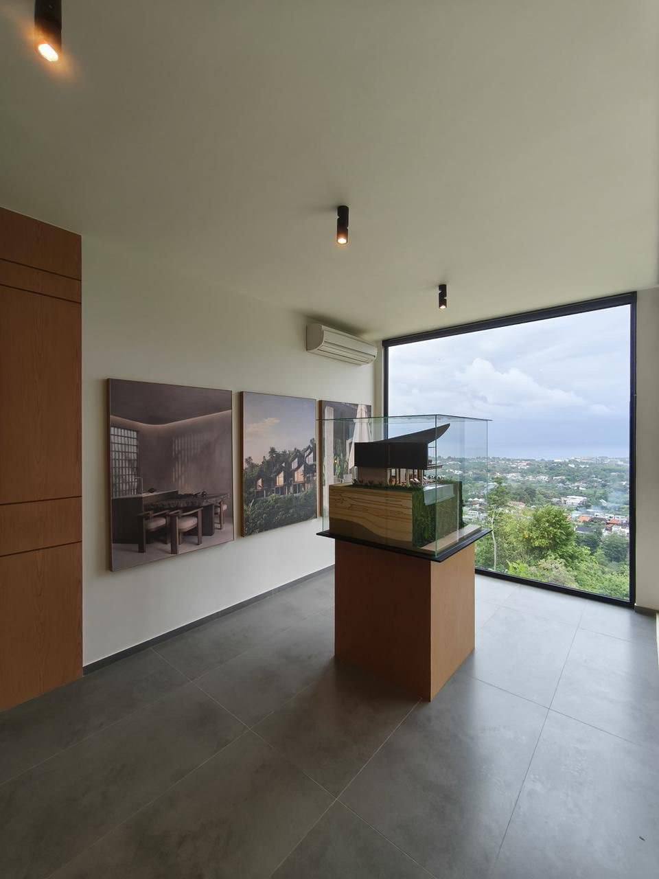 Office lounge with a scale model of the villas