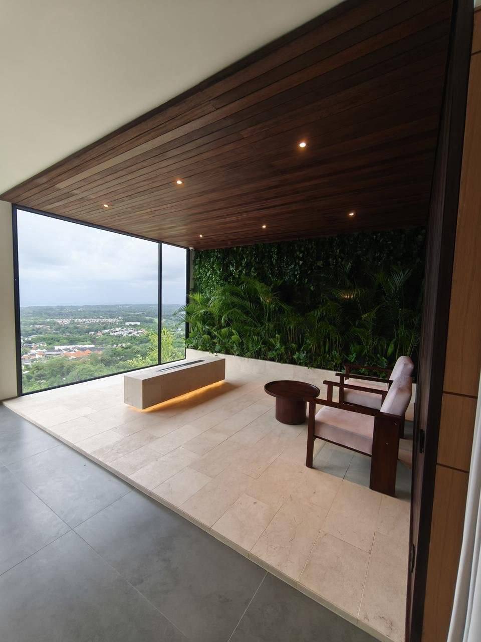 Terrace room with a fire feature and green wall