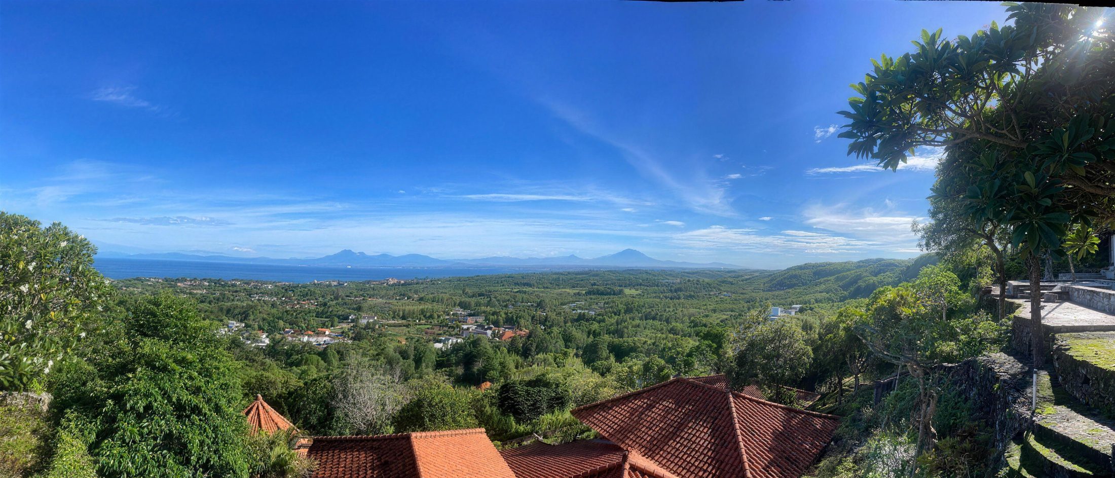 Panoramic view from the land over the Indian Ocean and volcanoes